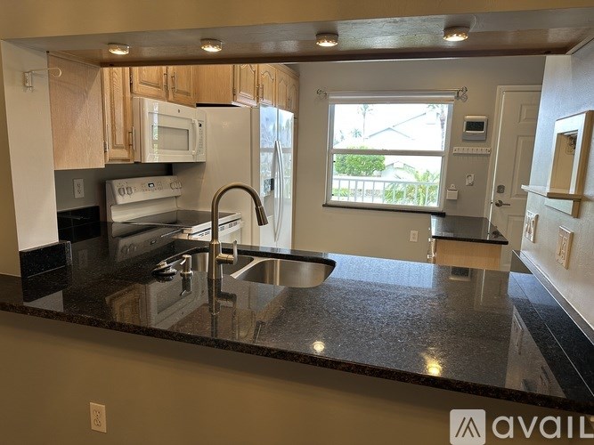A bathroom with a sink, mirror, and shower.