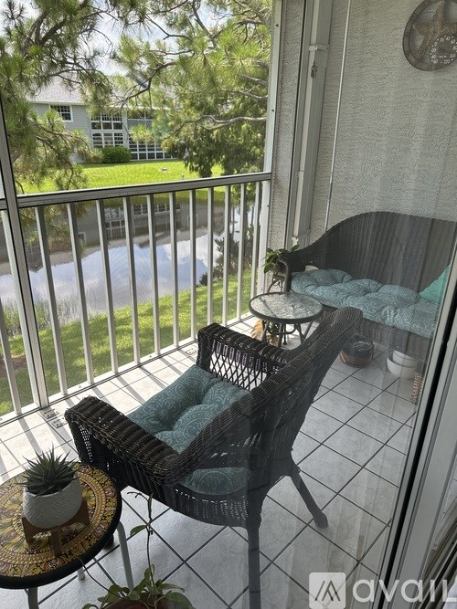 A balcony with a chair and table.