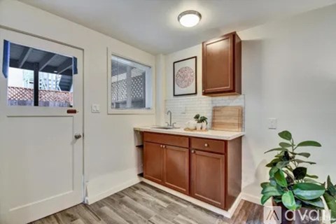 A kitchen with brown cabinets and a white countertop.