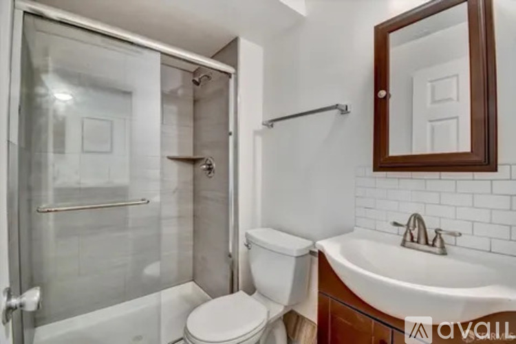 A white toilet sits next to a sink in a bathroom.