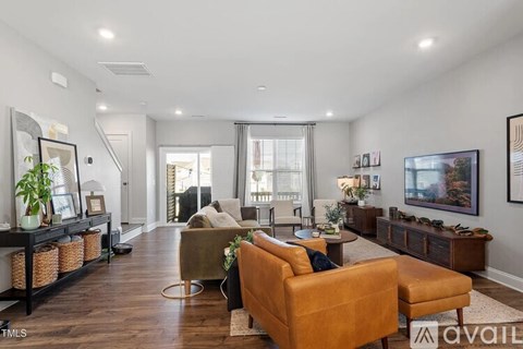 A living room with a brown leather sofa and a wooden coffee table.