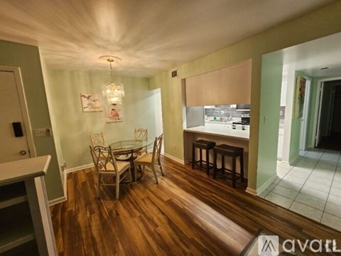 A dining room with a glass table and chairs.