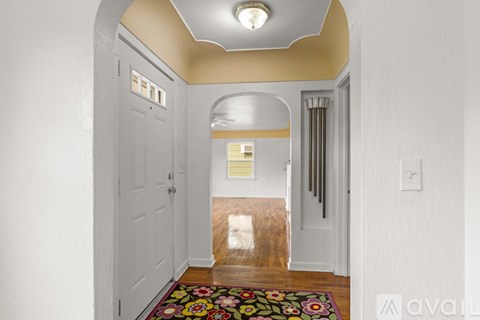 A hallway with a dog on the floor.