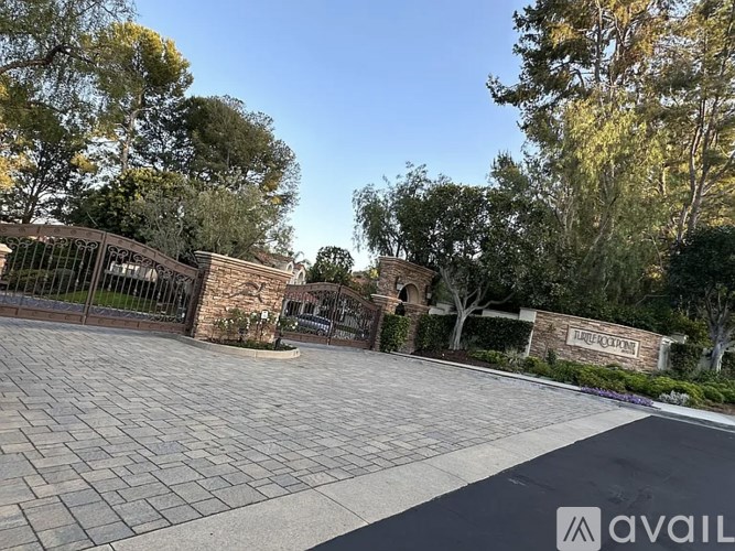 A driveway leads to a house with a sign that reads "AVAILABLE".