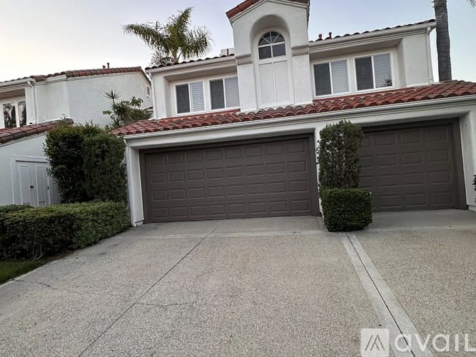 A house with a garage and a driveway.