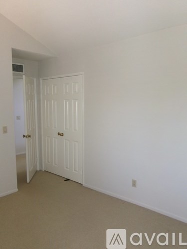 A white door is open to a hallway.