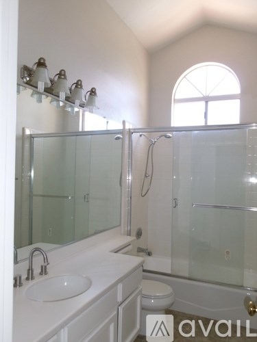 A bathroom with a sink, toilet, and bathtub.