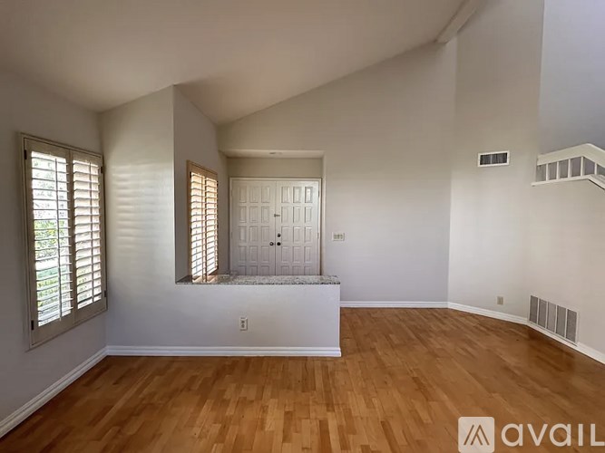 A room with wooden floors and a white door.