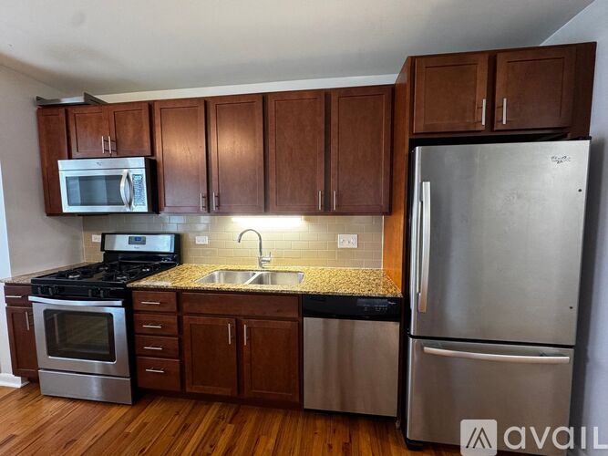 A kitchen with wooden cabinets and stainless steel appliances.
