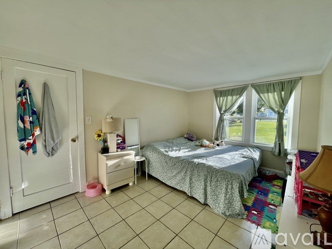 A bedroom with a bed, nightstand, and a wardrobe.