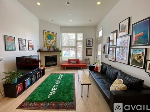 A living room with a green rug that says "Wet Grass" in the middle.