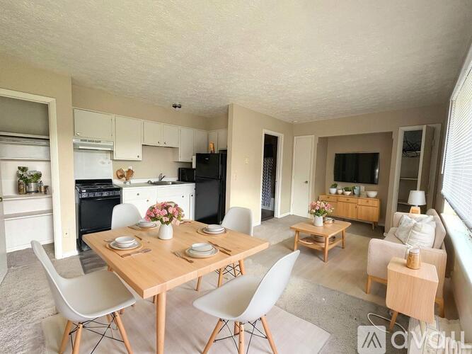 A kitchen with a table and chairs in the middle of the room.