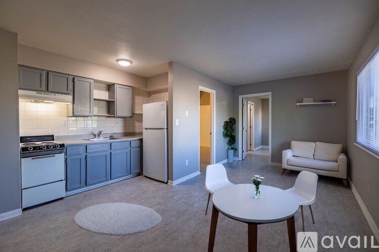 A kitchen with a table and chairs in the middle of the room.