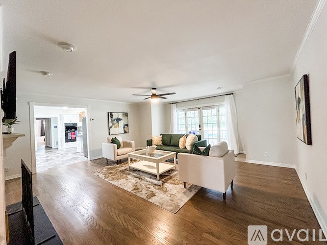 A living room with a white couch and a coffee table.