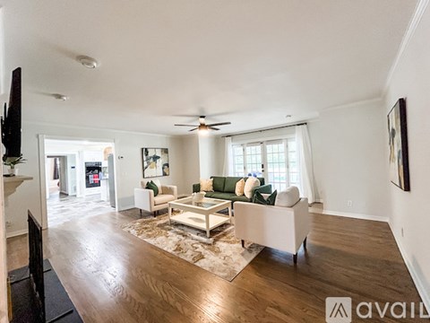 A living room with a white couch and a coffee table.