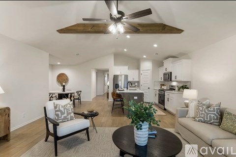 A modern living room with a wooden coffee table and a ceiling fan.