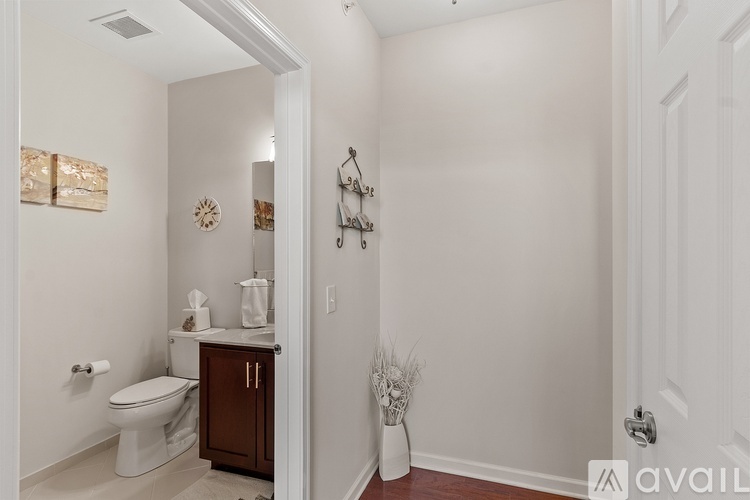 A bathroom with a toilet, sink, and a cabinet.