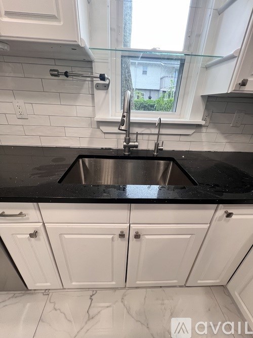 A bathroom with a toilet, sink, and mirror.