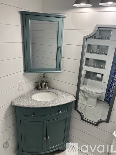 A bathroom with a sink and a mirror.