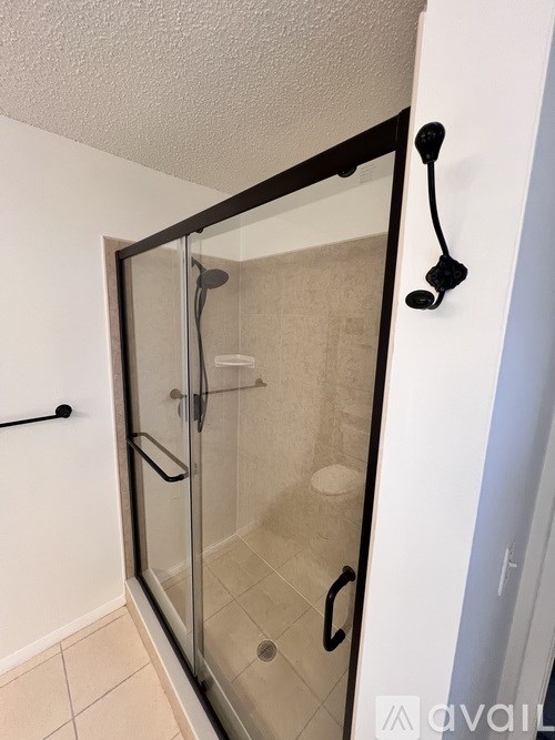 A glass shower door in a bathroom.