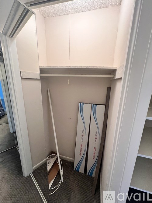 A small, empty room with a sign that says "available" on the bottom right.