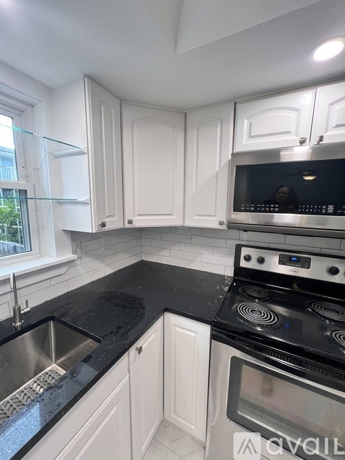 A room with wooden flooring and a ceiling fan.