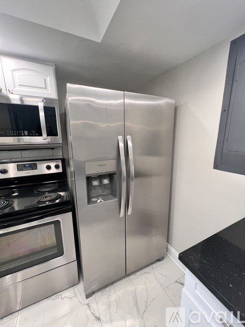 A balcony with a wooden floor and white walls.