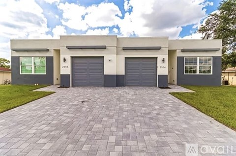A two-story garage with a driveway in front.