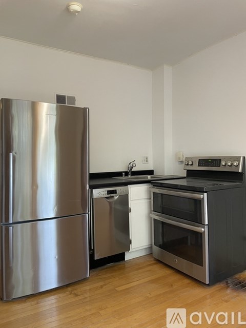 A kitchen with a stainless steel refrigerator and oven.