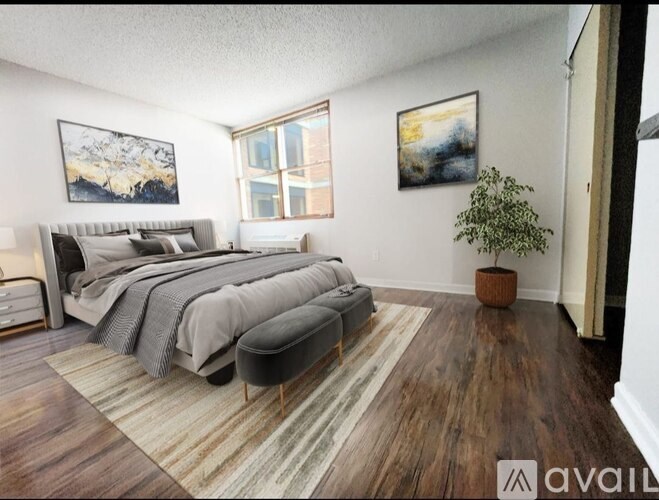 A bedroom with a large bed and a bench in front of it.