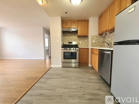 A kitchen with wooden cabinets and stainless steel appliances.
