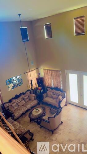 A living room with a couch and a television.