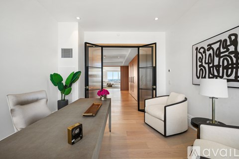 A modern living room with a long table and chairs.