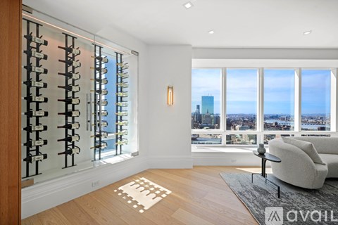 A living room with a view of the cityscape through the windows.