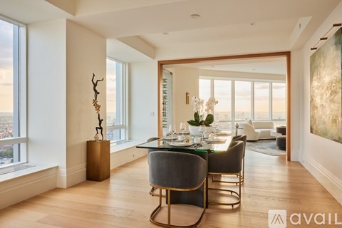 A modern dining room with a glass table and chairs.
