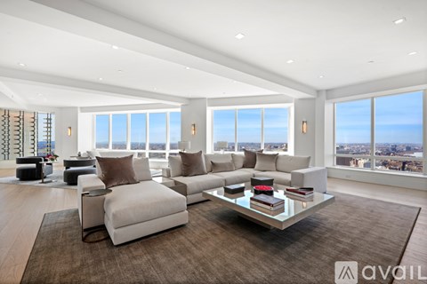 A spacious living room with a large sofa set and a coffee table.