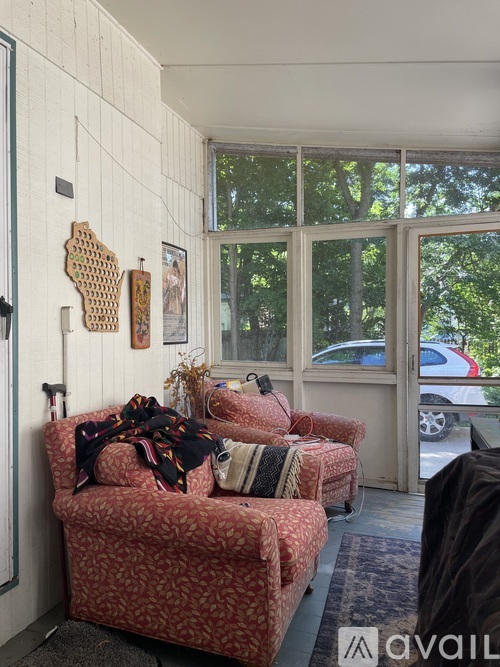 A living room with a couch and a rug.