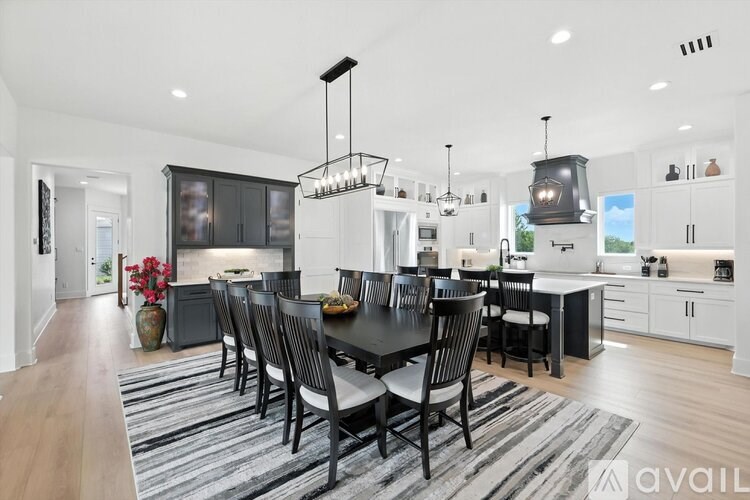 A modern kitchen with a dining table set for four.