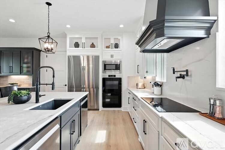 A modern kitchen with a black and white color scheme.