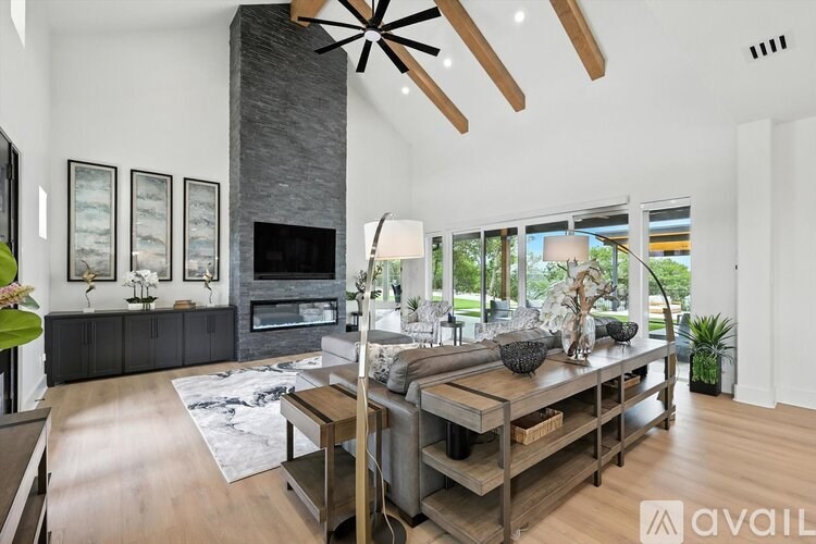 A modern living room with a fireplace and a wooden floor.
