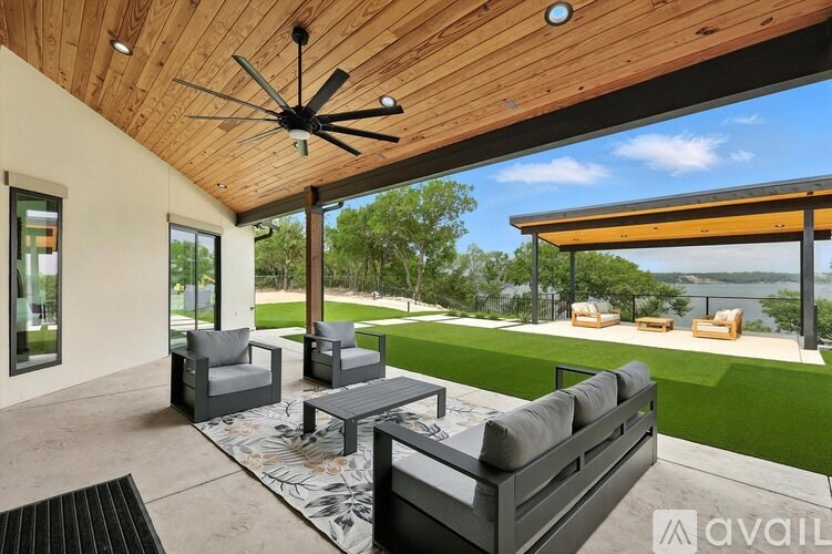 A patio with a ceiling fan and a couch.