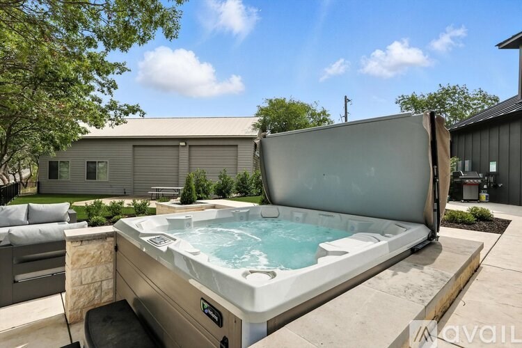A hot tub is in the middle of a patio.