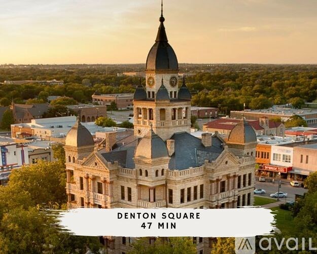 A large building with a clock tower is located in Denton Square.