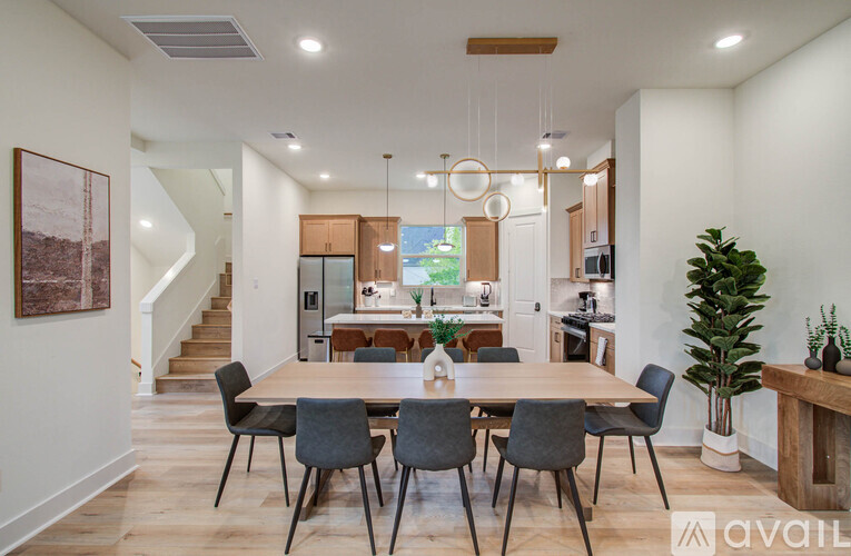 A dining room with a wooden table and chairs.