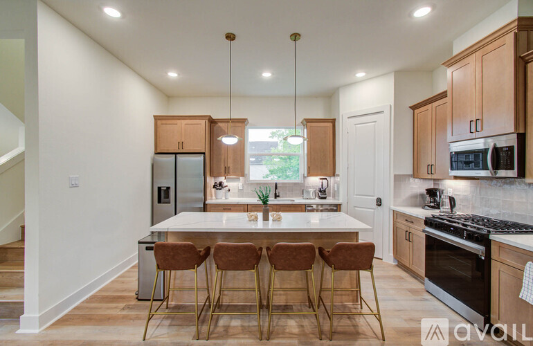 A kitchen with a table and chairs in the middle of it.