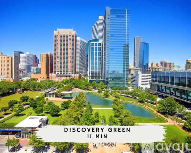 A cityscape with a large green space in the foreground and a sign that reads "Discovery Green II Min.".