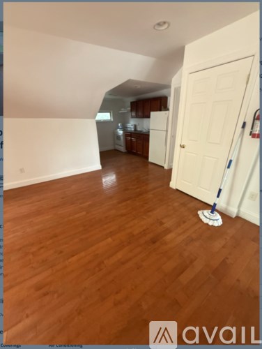 A room with wooden floors and a white door.