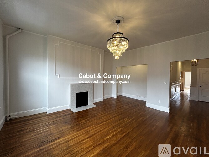 A living room with a blue couch and a coffee table.