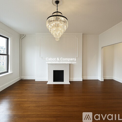 A living room with a fireplace and a TV on the wall.