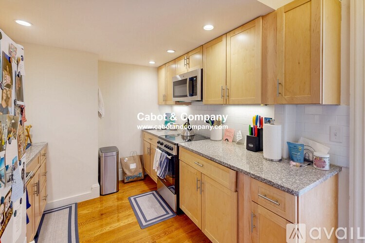 A kitchen with wooden cabinets and a granite countertop.